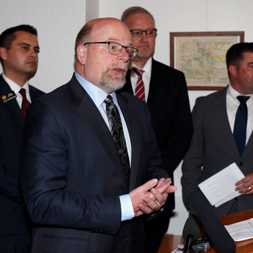 Barry Arrington, front, an attorney representing the gun advocacy group Rocky Mountain Gun Owners, speaks as a handful of Republican lawmakers, from back left, representatives Dave Williams, Stephen Humphrey and Patrick Neville, look on as plans are outlined to file a lawsuit to block a "red flag" law allowing courts to order firearms be taken away from people who pose a danger during a news conference in the State Capitol Thursday, May 2, 2019, in Denver. The Republicans and the group claim that House Democrats violated a section of the state constitution governing the legislative process to get the bill passed earlier this year. (AP Photo/David Zalubowski)